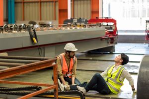 man attending to injured worker